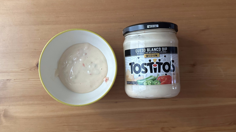 Tostitos Medium Queso Blanco Dip in bowl on wooden table