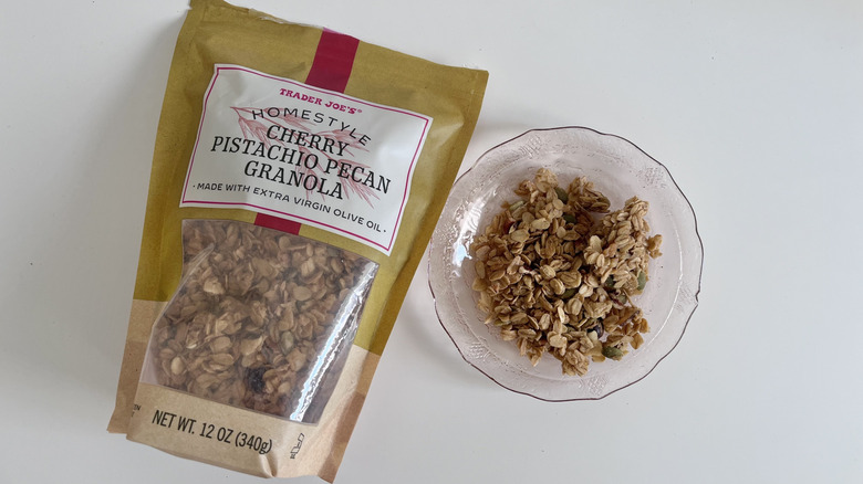 Bag of Homestyle Cherry Pistachio Pecan Granola from Trader Joe's next to small bowl of granola