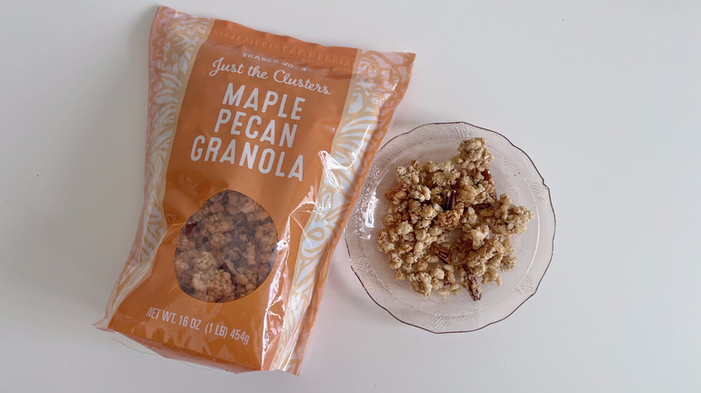 Top view of Just the Clusters Maple Pecan Granola Cereal from Trader Joe's next to small bowl of granola