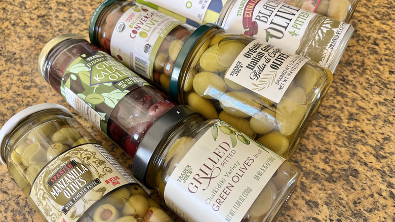 Various Trader Joe's olives on a counter top