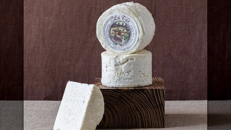 Round of La Tur cheese with wedge removed to show interior