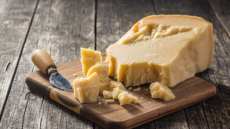 Block of Parmesan on a cutting board