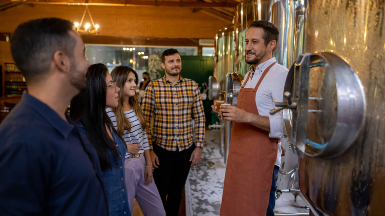 Group of people taking a tour at a brewery