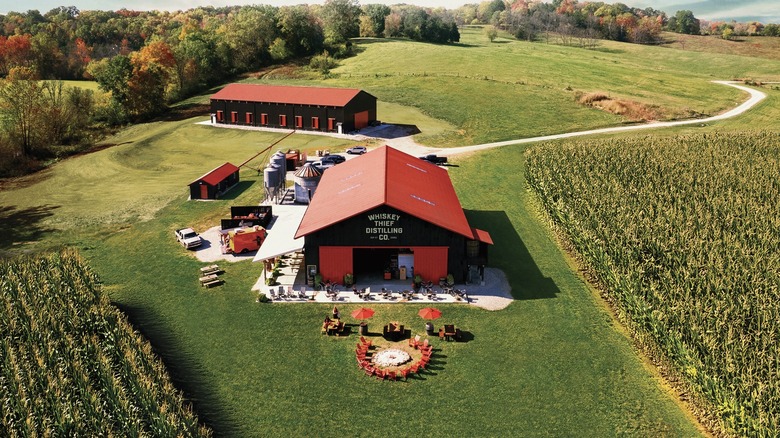 The Whiskey Thief Distilling Co. distillery shown from an aerial shot showing the surrounding fields