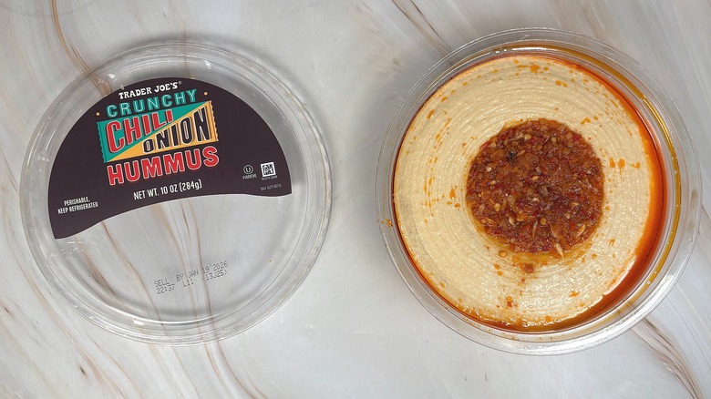 Top-down shot of open container of Trader Joe's Crunchy Chili Onion Hummus