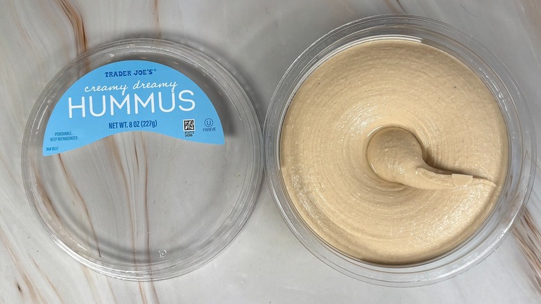 Top-down shot of open container of Trader Joe's Creamy Dreamy Hummus