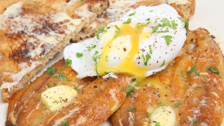 buttered kippers served with toast and a poached egg