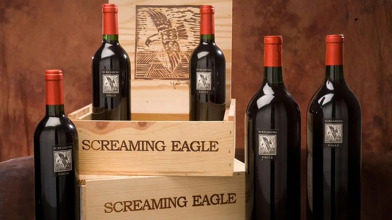 Bottles of Screaming Eagle wine on a tabletop and in wooden crates
