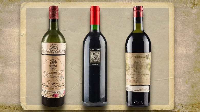 Three bottles of vintage wine against an old parchment paper backdrop