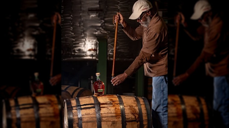 bourbon being pulled from a barrel at A. Smith Bowman Distillery
