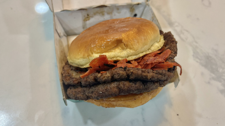 Wahlburgers Pepperoni Smash burger in to-go box.