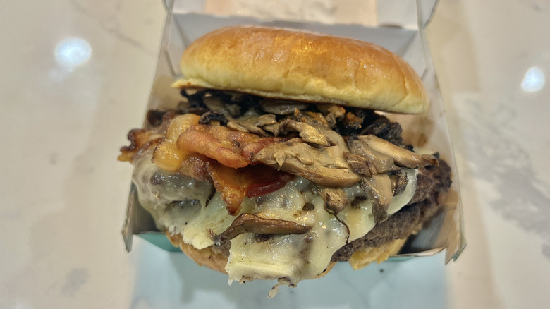 Wahlburgers O.F.D. burger in to-go box.