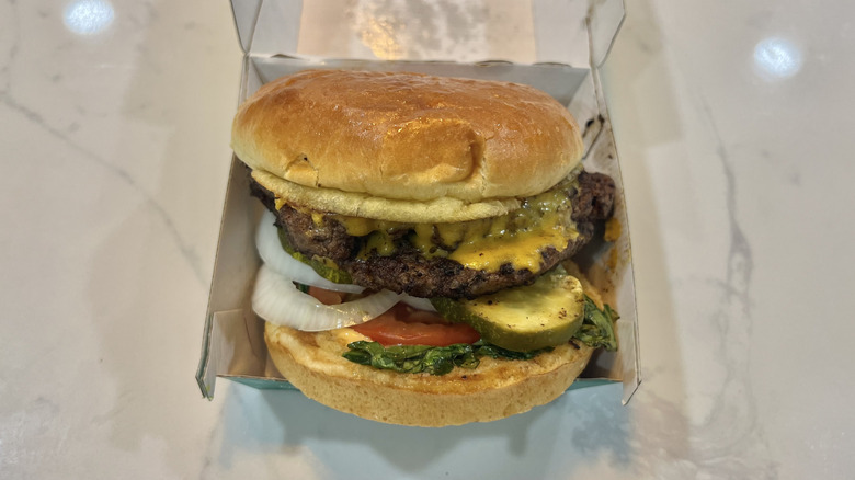 Wahlburgers The Double Decker burger in to-go box.