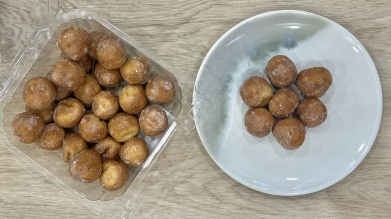 Freshness Guaranteed Old Fashioned Glazed Donut Holes on plate.