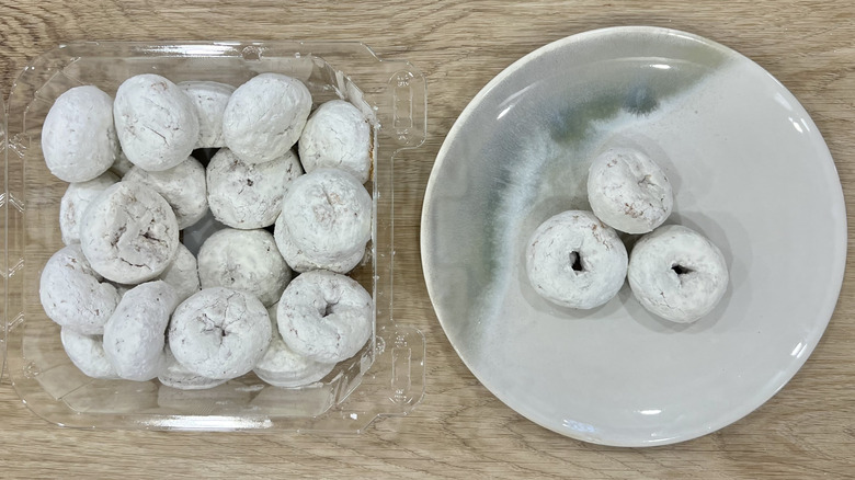 Freshness Guaranteed Powdered Sugar Mini Donuts on plate.