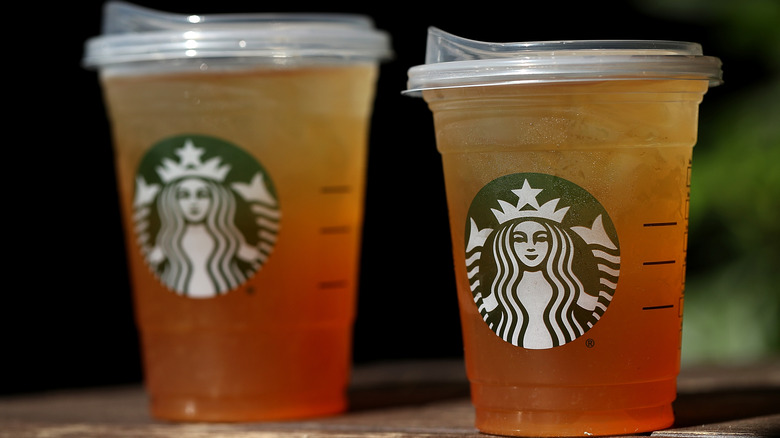 Two Starbucks iced teas in clear cold cups next to each other