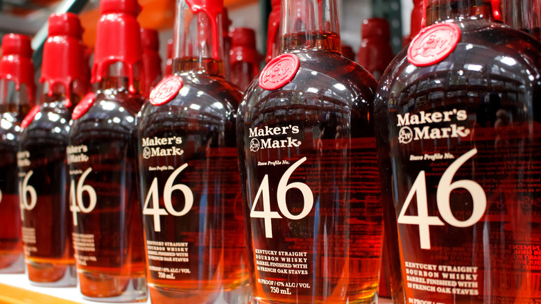 A line of Maker's Mark 46 bottles being presented on a liquor store shelf