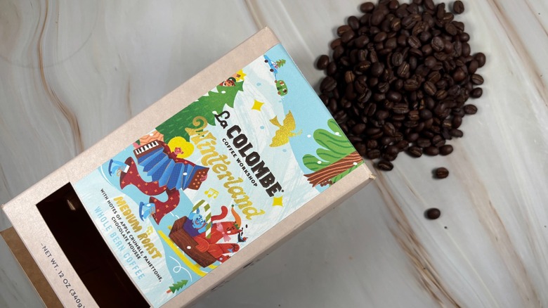 Top-down shot of coffee beans spilling out of box of La Colombe holiday blend
