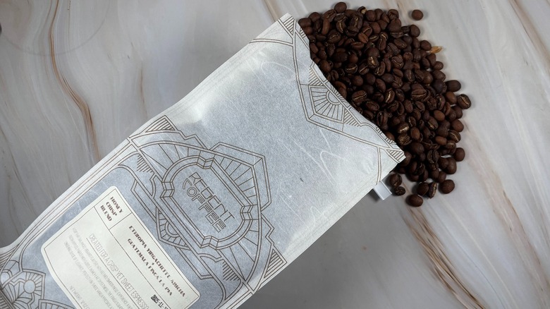 Top-down shot of coffee beans spilling out of bag of Regent holiday blend