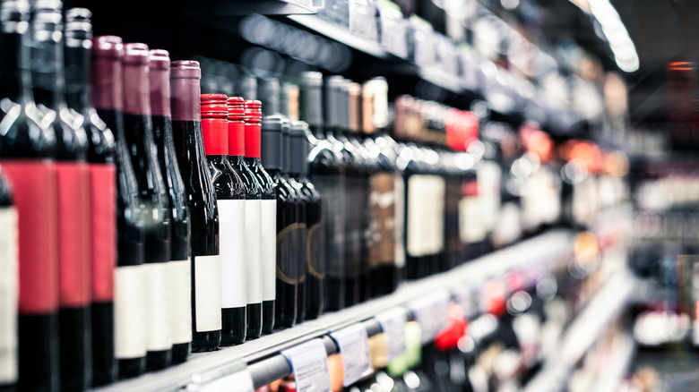 Rows of red wine on a store shelf
