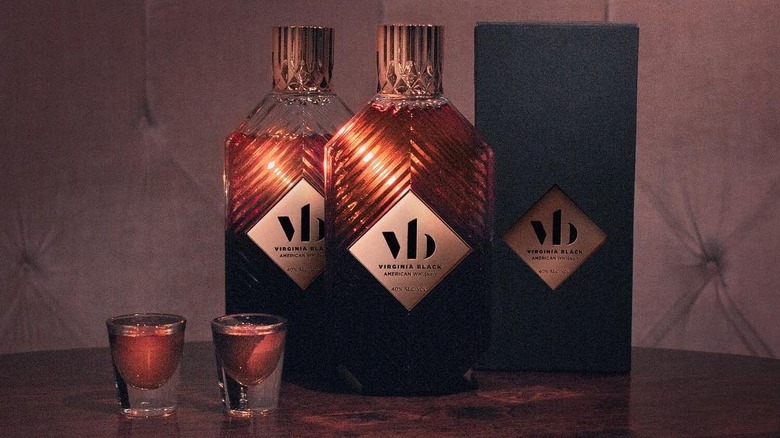 Two bottles of Virginia Black Whiskey and the box shown with two shots of the spirit