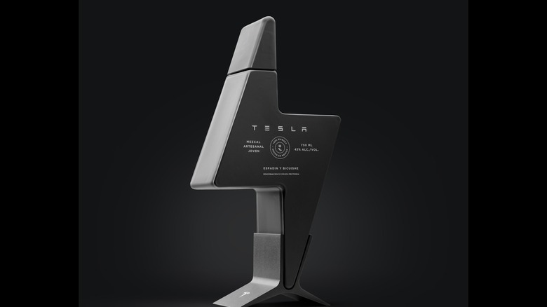 Tesla Mezcal with its unique bottle resting on its stand with a plain dark background