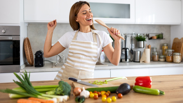 someone singing in a kitchen while cooking