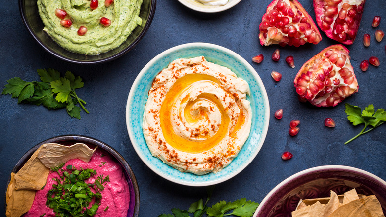 different flavors of hummus and toppings
