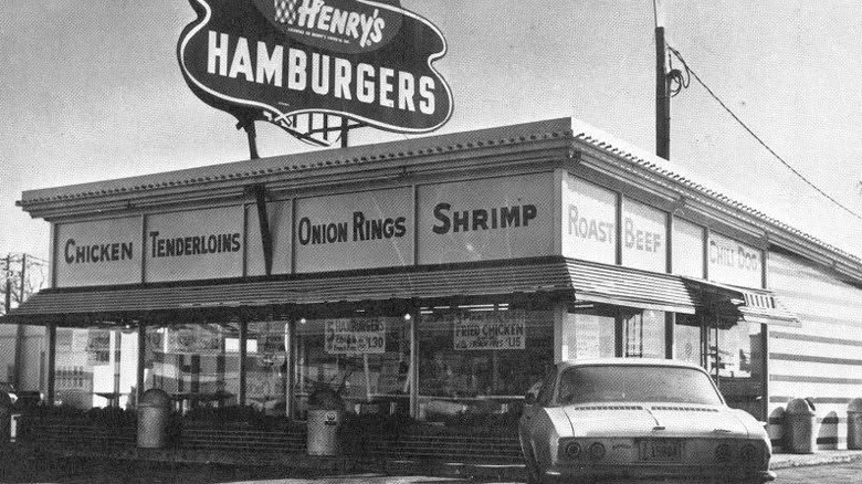 black and white image of Henry's Hamburgers restaurant with car parked outside