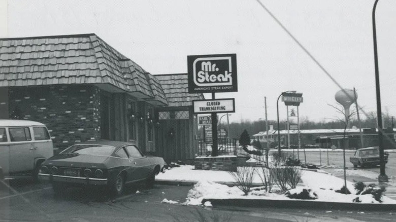Black and white image of Mr. Steak restaurant with cars parked outside