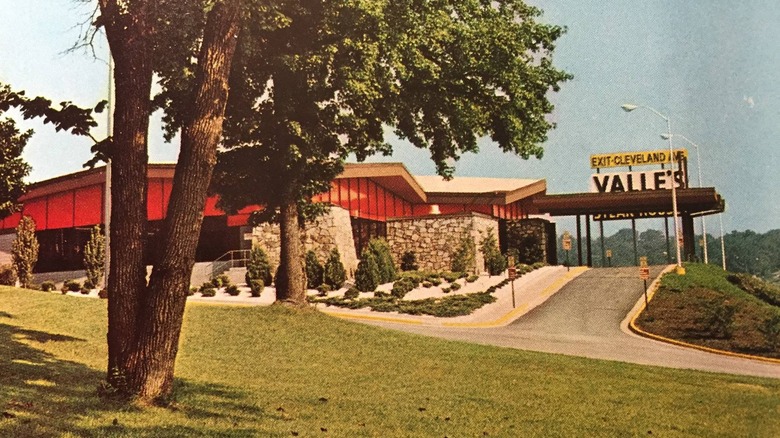 Vintage image of Valle's steakhouse with drive, green grass, and tree