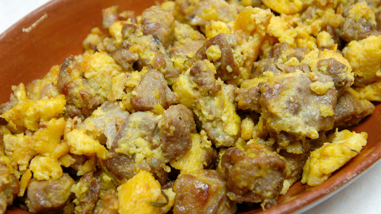 close up of Agnello cacio e ova on tan serving dish