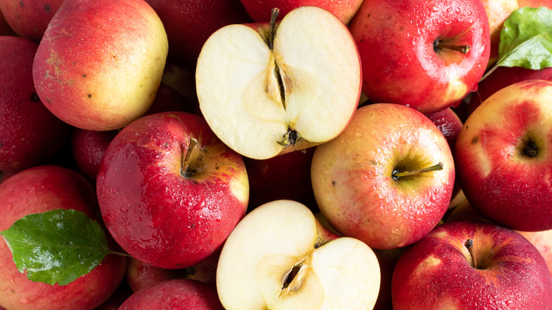 A top-down view of Jonathan apples, one cut in half.