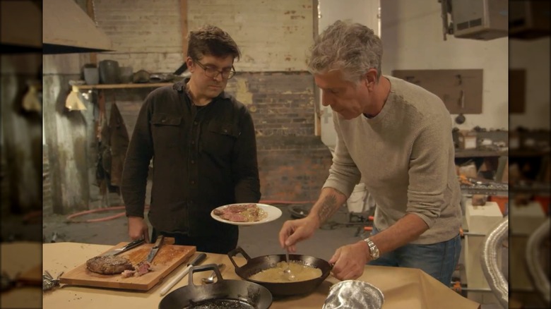Anthony Bourdain preparing a steak dish