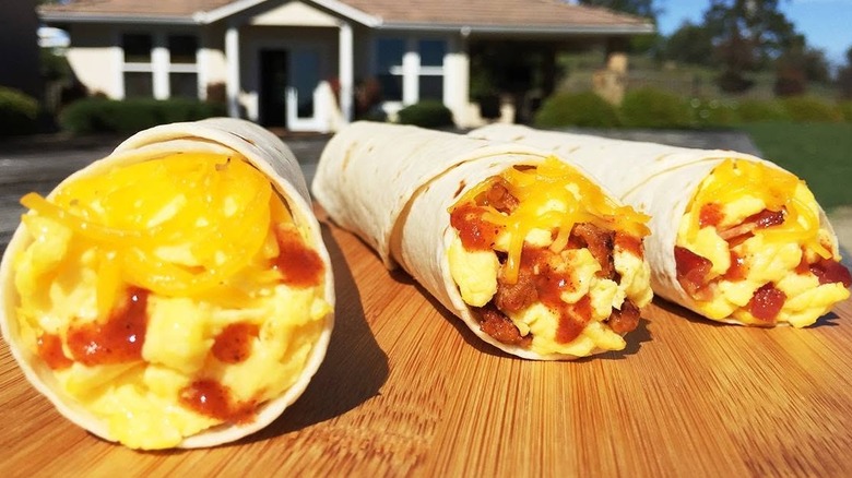 Three Breakfast Rollers from Del Taco on a table