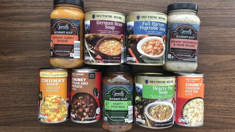 9 different bottles and cans of Aldi soup.