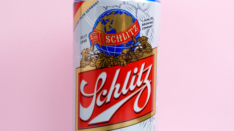 Schlitz beer can on pink background