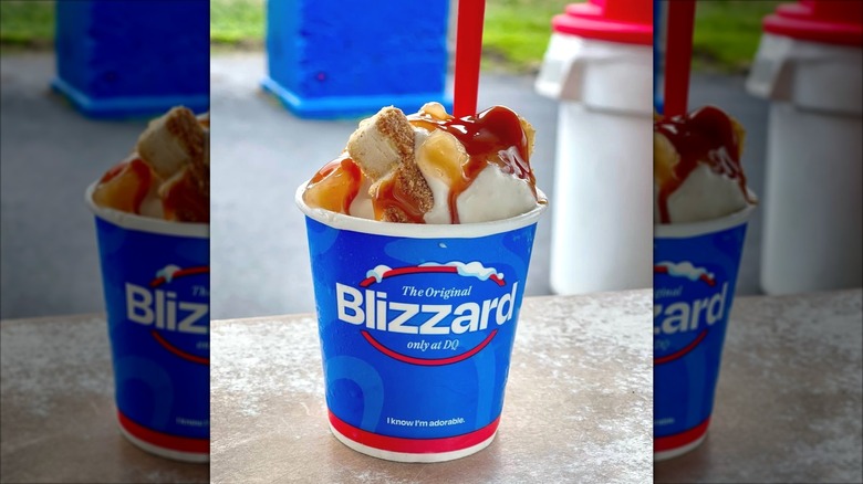Dairy Queen Caramel Apple Cheesecake Blizzard sitting on concrete table