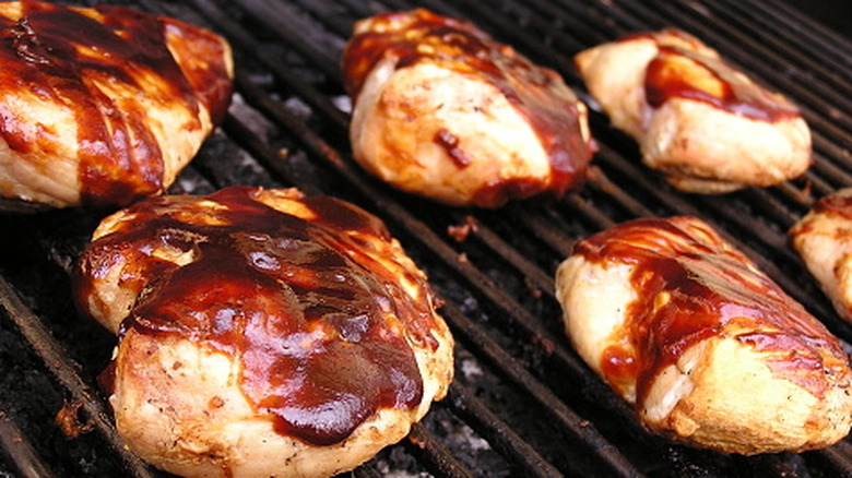Saucy BBQ chicken on grill