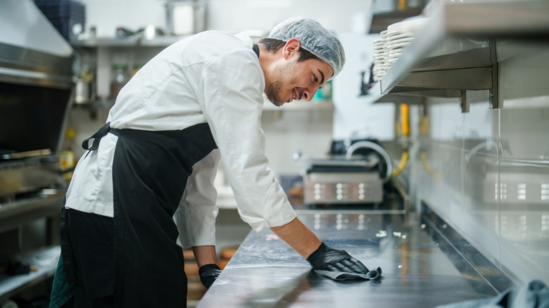 Chef deep cleaning a restaurant kitchen