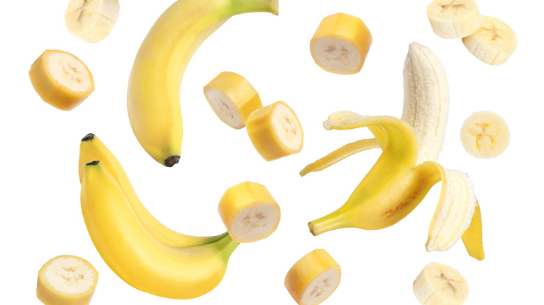 Yellow bananas surrounded by sliced up banana rounds