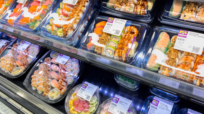 Trays of sushi at refrigerated section of grocery store