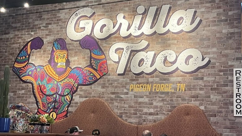 Mural inside Gorilla Taco restaurant featuring artistically rendered gorilla wrestler showing muscles