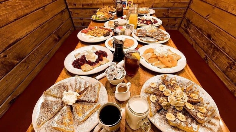 Table in booth fully set with breakfast items