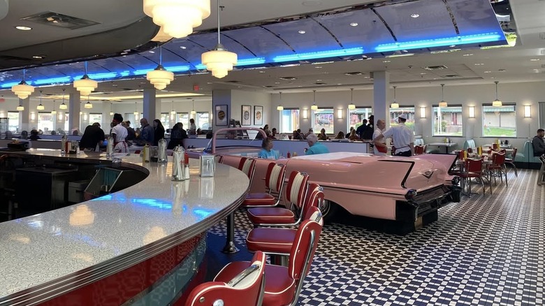 Interior of Sunliner Diner with classic car booth and bar seating visible