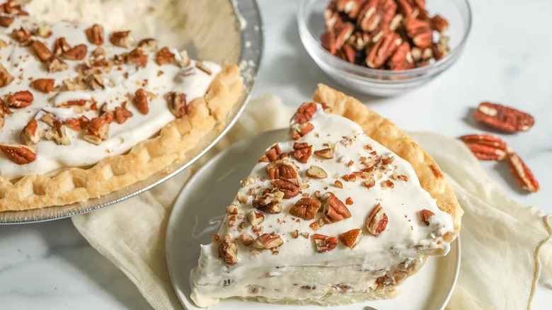 Slice of Maple Pecan Cream Pie on white plate