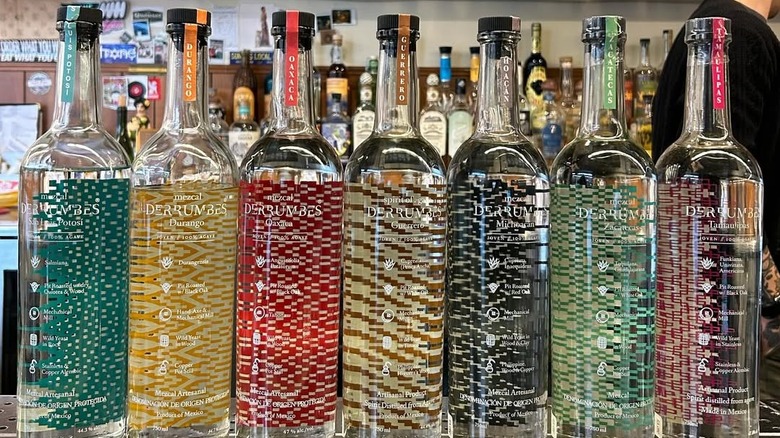 Different bottles of Mezcal Derrumbes on the bar