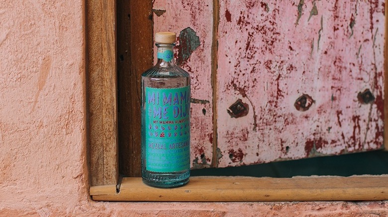 Bottle of Mi Mamá me Dijo Mezcal in doorway