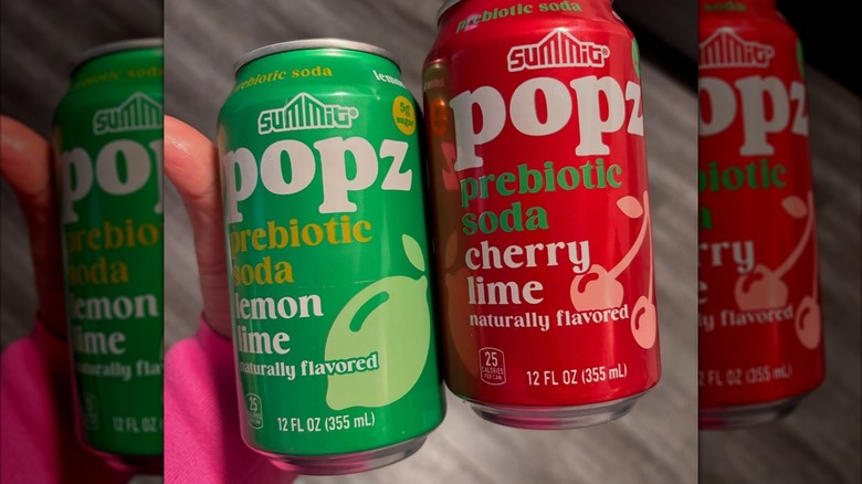Red and green cans of Popz prebiotic soda