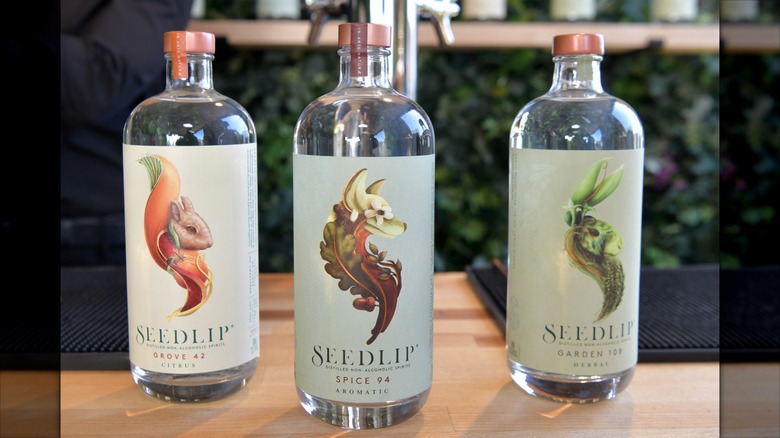 Three bottles of Seedlip on wooden table
